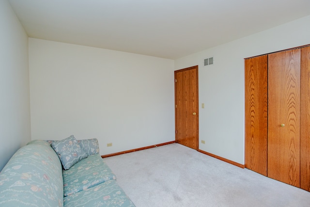 living area featuring light colored carpet