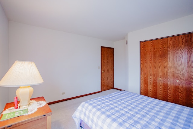 bedroom with a closet and light colored carpet