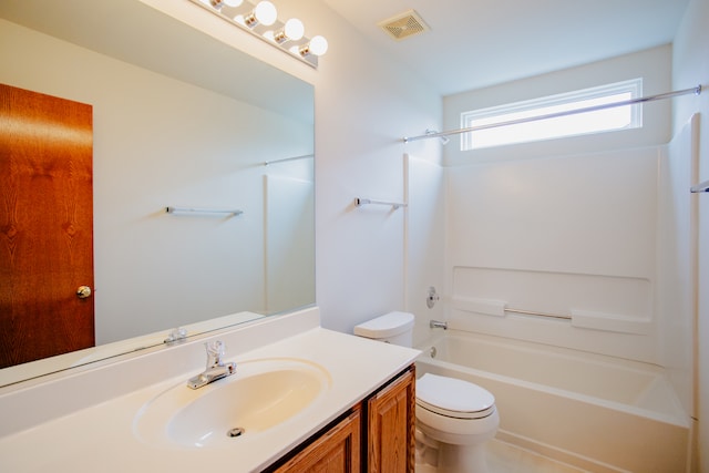 full bathroom featuring vanity, shower / bath combination, and toilet