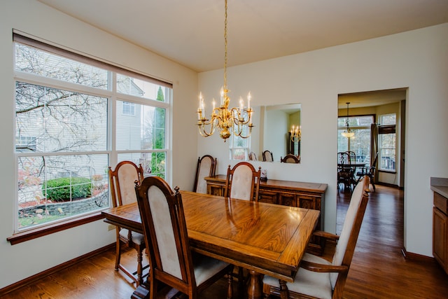 dining space featuring an inviting chandelier and dark wood-type flooring