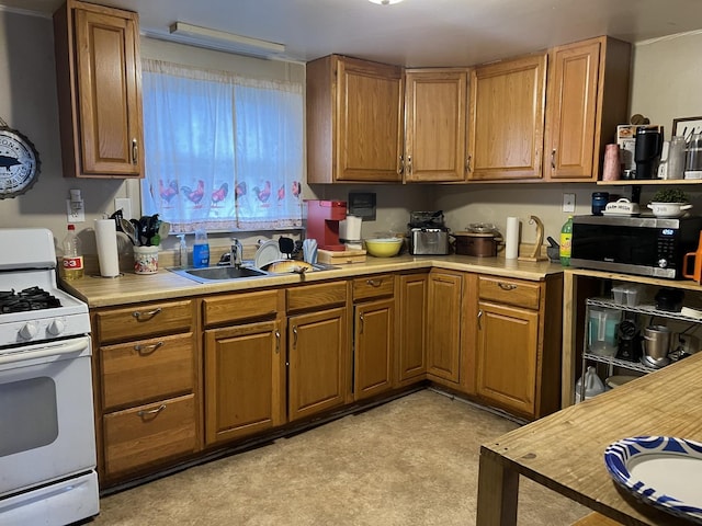 kitchen featuring sink and white gas range oven