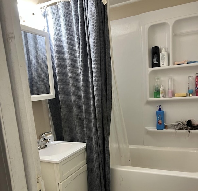 bathroom featuring shower / bath combo with shower curtain and vanity