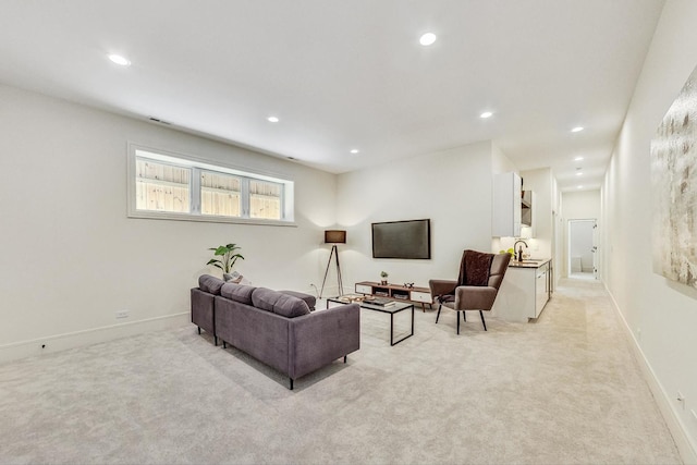 living room featuring sink and light colored carpet