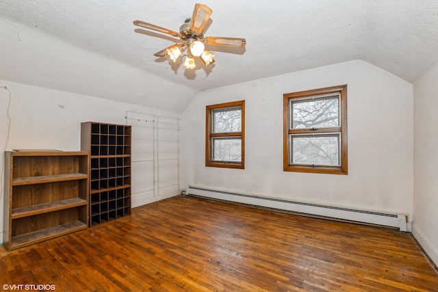 bonus room with dark hardwood / wood-style floors, lofted ceiling, and a baseboard radiator