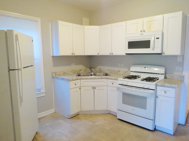 kitchen featuring white cabinets, white appliances, and sink