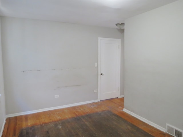 spare room featuring wood-type flooring