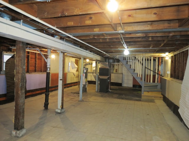 basement featuring gas water heater and heating unit