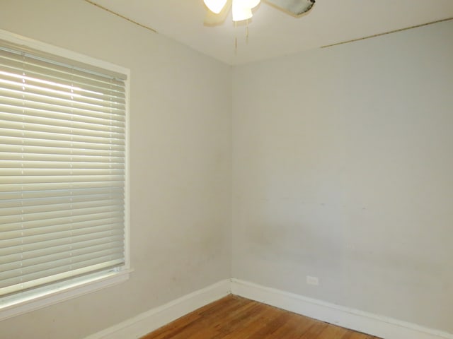 spare room featuring hardwood / wood-style flooring and ceiling fan