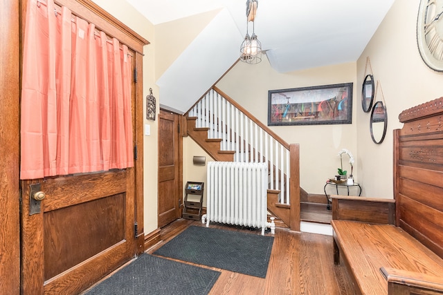 entryway with radiator and dark wood-type flooring