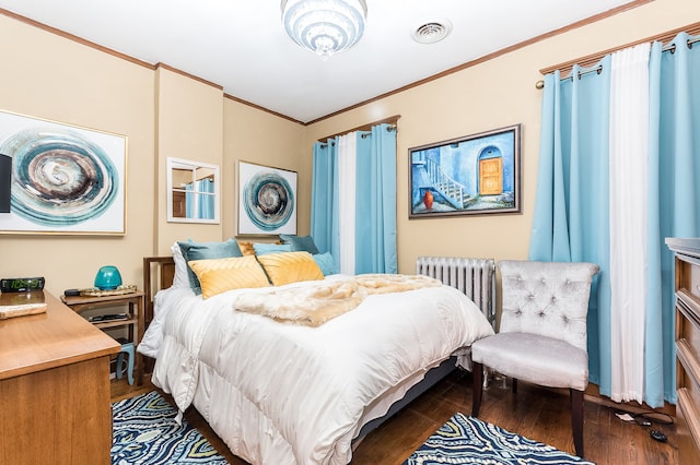 bedroom with dark hardwood / wood-style floors, crown molding, and radiator