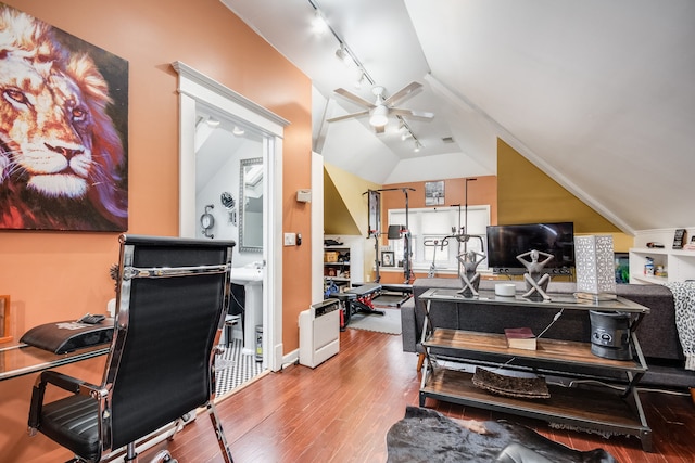 home office featuring ceiling fan, hardwood / wood-style floors, track lighting, and vaulted ceiling