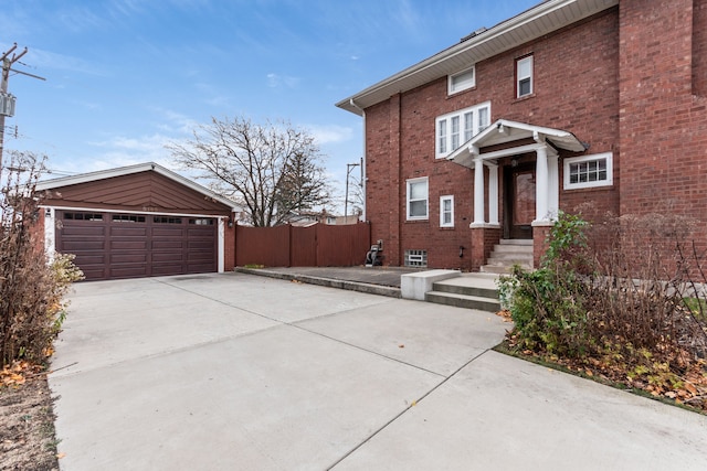 view of side of home featuring a garage and an outdoor structure