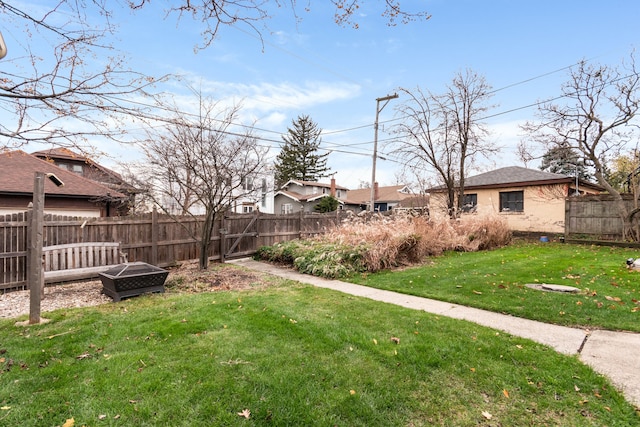 view of yard with a fire pit