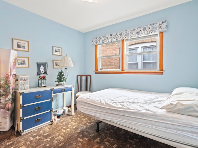 bedroom featuring dark parquet flooring