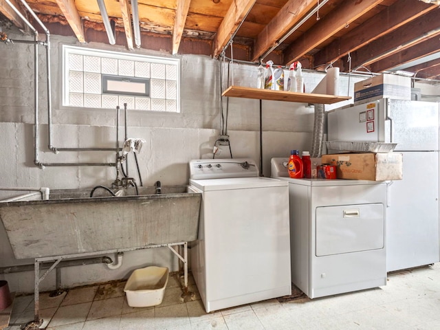 laundry area featuring washing machine and dryer and sink