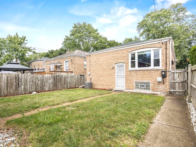 exterior space with central AC unit and a front lawn