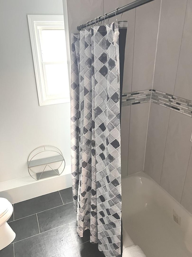 bathroom with shower / tub combo and toilet