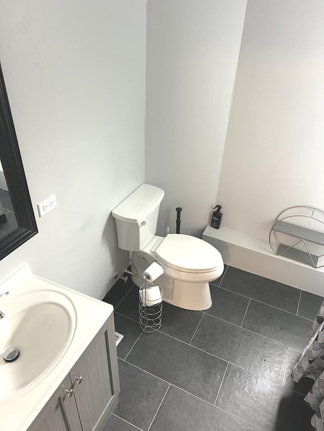 bathroom featuring tile patterned floors, vanity, and toilet