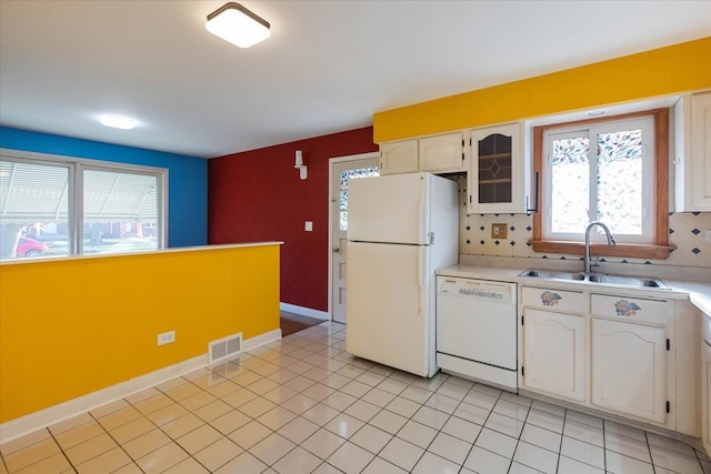 kitchen with white cabinets, white appliances, sink, and light tile patterned floors