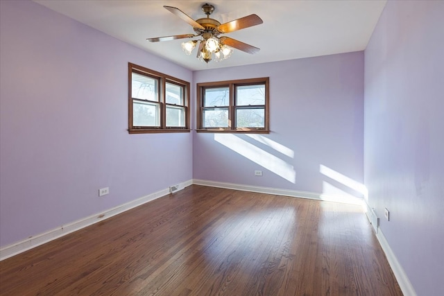 spare room featuring dark hardwood / wood-style floors and ceiling fan