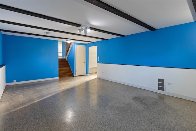 empty room featuring beam ceiling