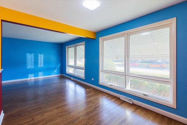 empty room featuring dark hardwood / wood-style flooring