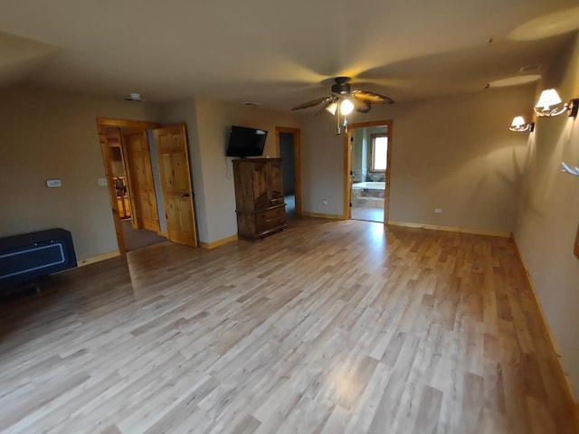 unfurnished living room featuring ceiling fan and light hardwood / wood-style flooring