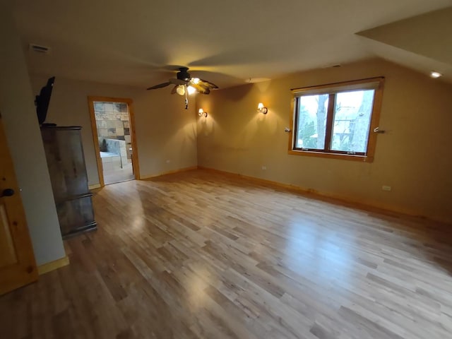 unfurnished living room with ceiling fan, lofted ceiling, and light hardwood / wood-style floors