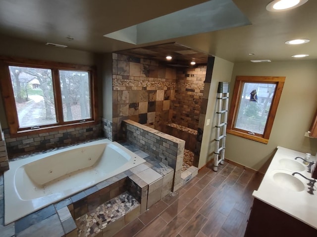 bathroom featuring separate shower and tub and vanity