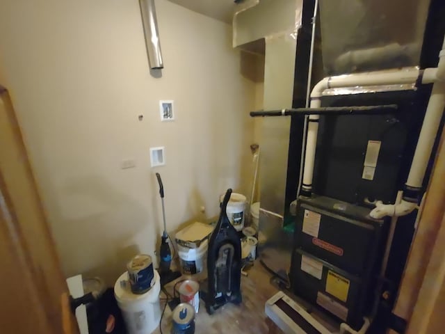 utility room featuring heating unit