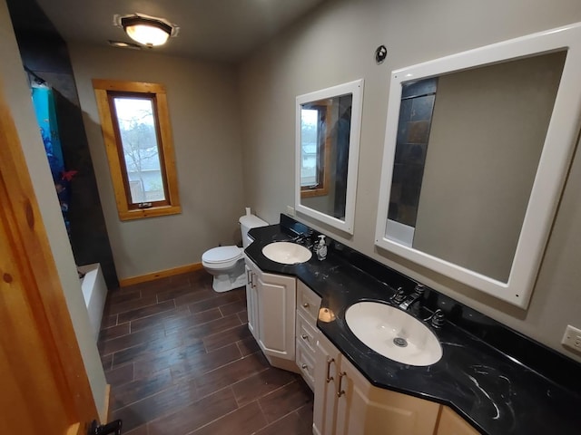 bathroom with a shower, toilet, and vanity