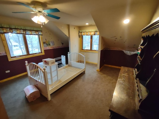 bedroom with ceiling fan, carpet flooring, and multiple windows