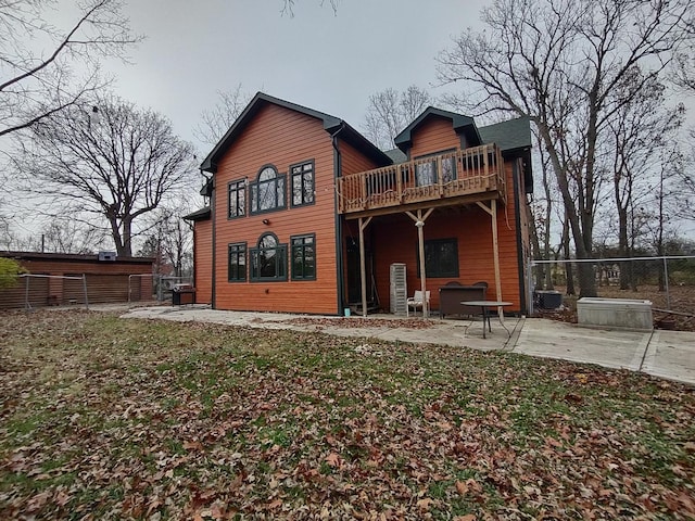 rear view of property featuring a patio area and a yard