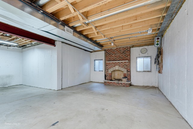 basement featuring a brick fireplace and a wealth of natural light