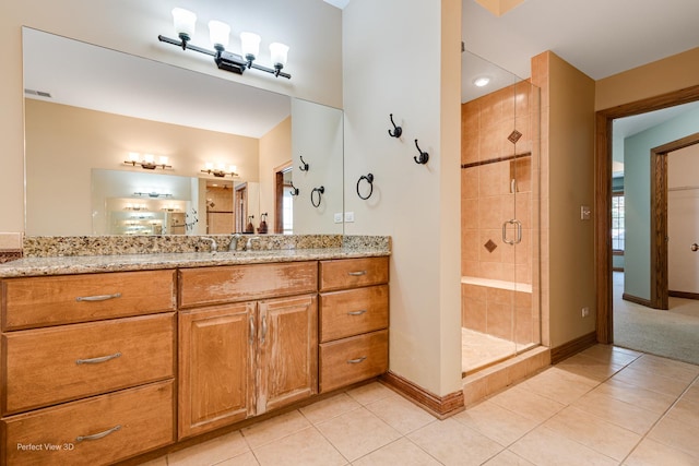 bathroom with vanity, tile patterned floors, and a shower with shower door