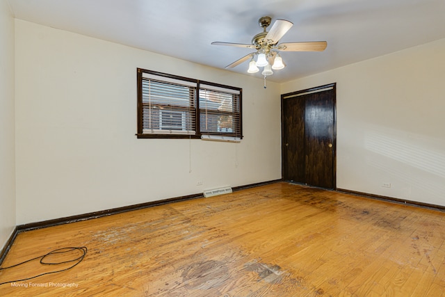 spare room featuring ceiling fan and light hardwood / wood-style flooring