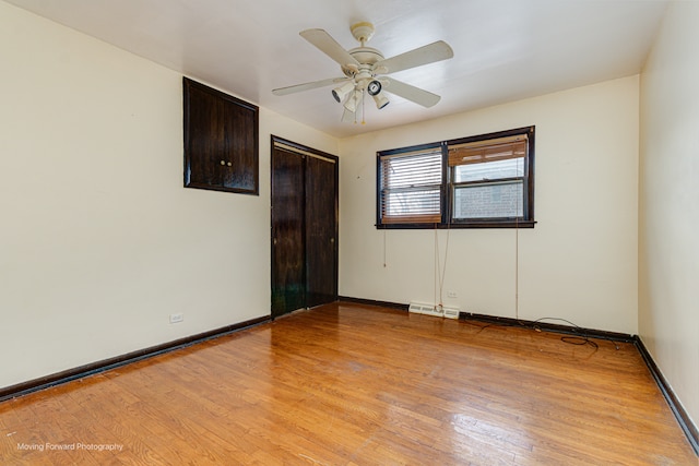 spare room with ceiling fan and light wood-type flooring