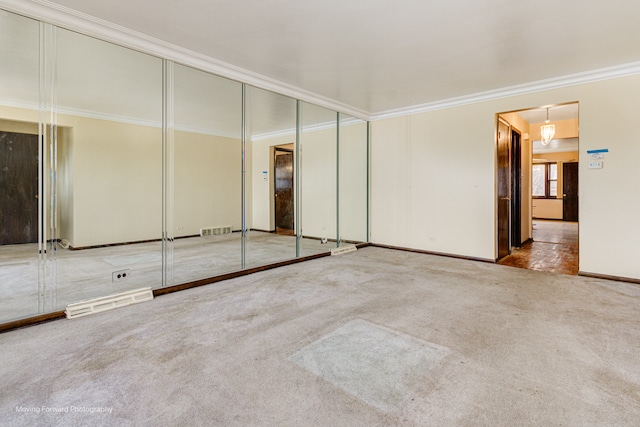 unfurnished bedroom featuring crown molding, a closet, and carpet