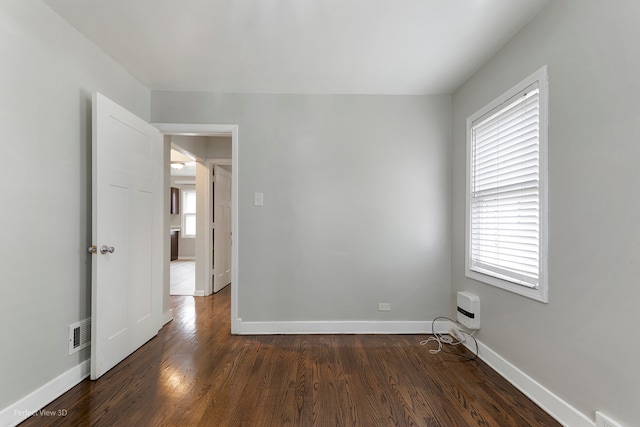 empty room featuring dark wood-type flooring