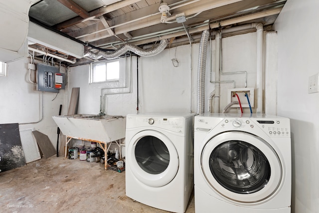 washroom featuring washer and dryer, sink, and electric panel