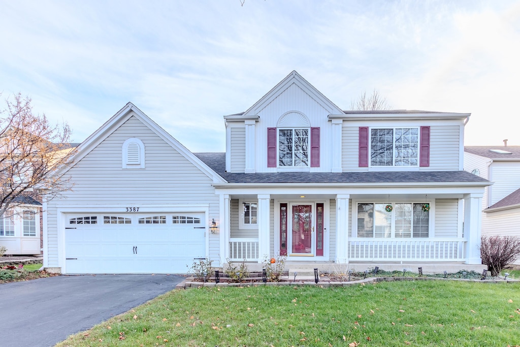 view of front facade with a garage and a front lawn