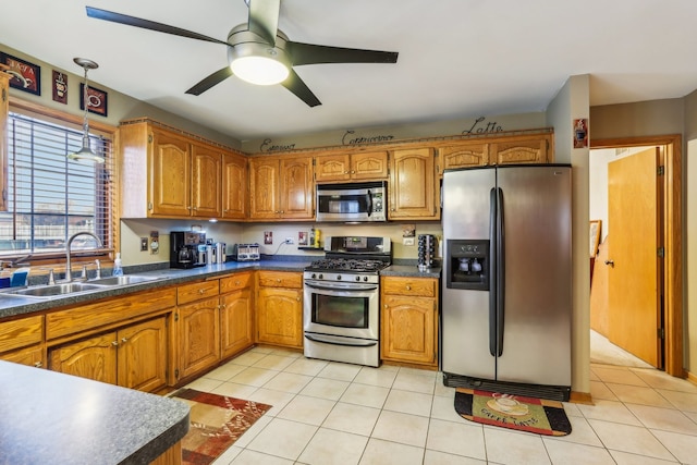 kitchen with ceiling fan, sink, light tile patterned floors, and stainless steel appliances