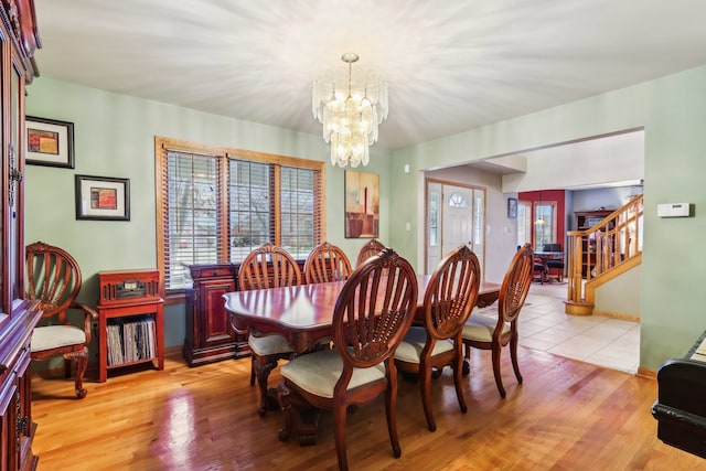 dining area with a chandelier and light wood-type flooring