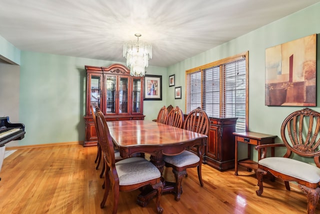 dining space featuring a notable chandelier and light hardwood / wood-style flooring