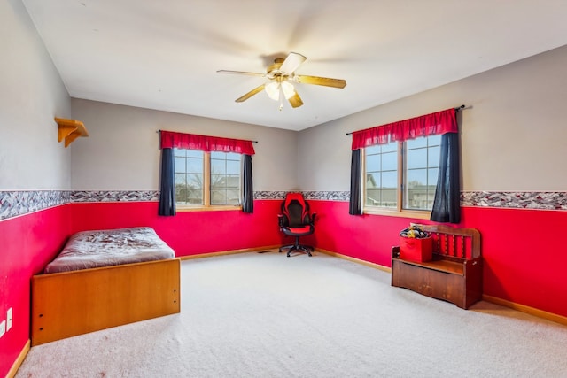 bedroom with light colored carpet, multiple windows, and ceiling fan