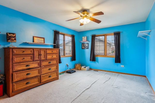 carpeted bedroom featuring ceiling fan and multiple windows