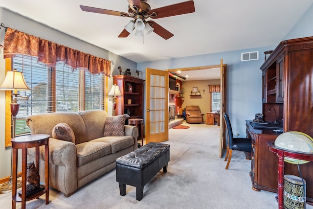 living room featuring ceiling fan, light colored carpet, and french doors