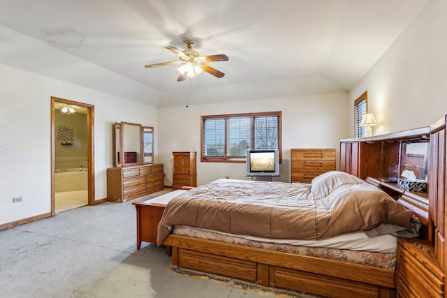 bedroom with ceiling fan, vaulted ceiling, and ensuite bath