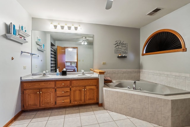 bathroom featuring tile patterned floors, vanity, a relaxing tiled tub, and ceiling fan