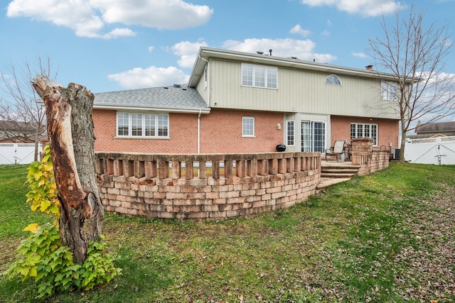 back of property featuring a yard